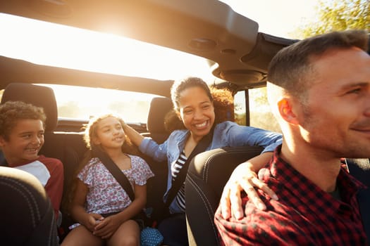 Happy family on a road trip in car, front passenger POV