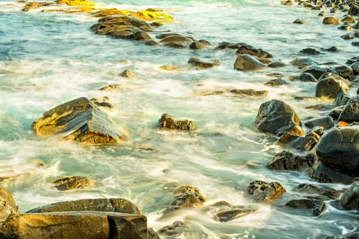 Surf of the Atlantic Ocean with rocks in long exposure