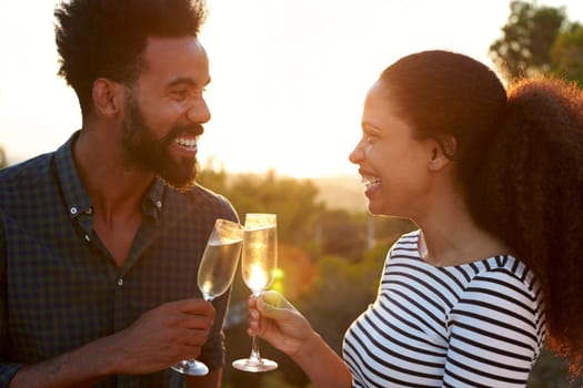 Romantic couple making a toast outdoors