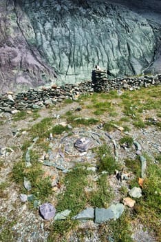 The mountain river in the mountains. Current through the gorge the river. Stones and rocky land near the river. Beautiful mountain landscape.