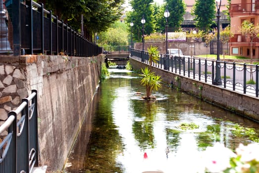 City landscape with a small river.   City of Scafati, Italy. Architecture of a small southern Italian town.
