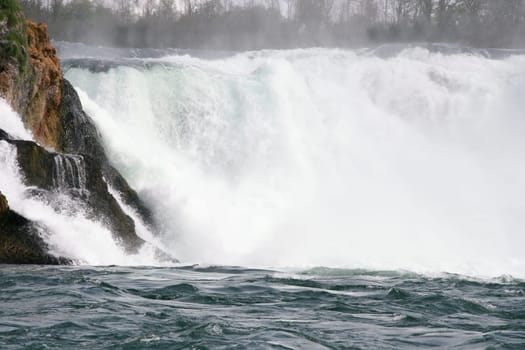 Waterfall with white,foaming spray