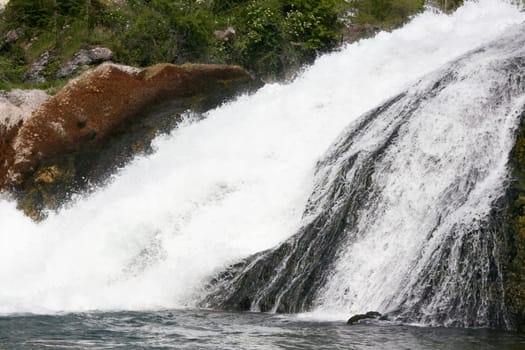 Waterfall with white,foaming spray