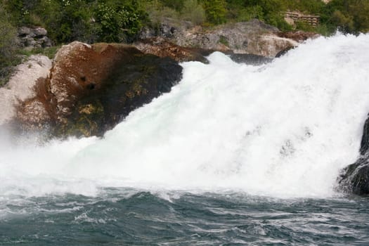 Waterfall with white,foaming spray
