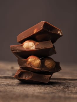 Close up of stacked chocolate bars on a wooden table