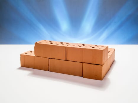 indicated masonry of toy bricks on a white background against a star-shaped blue illuminated background