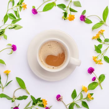 Meadow flowers and wildflowers arranged in circle with coffe cup. Flat lay.