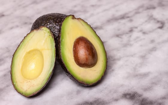 closeup cut fresh avocado on marble surface