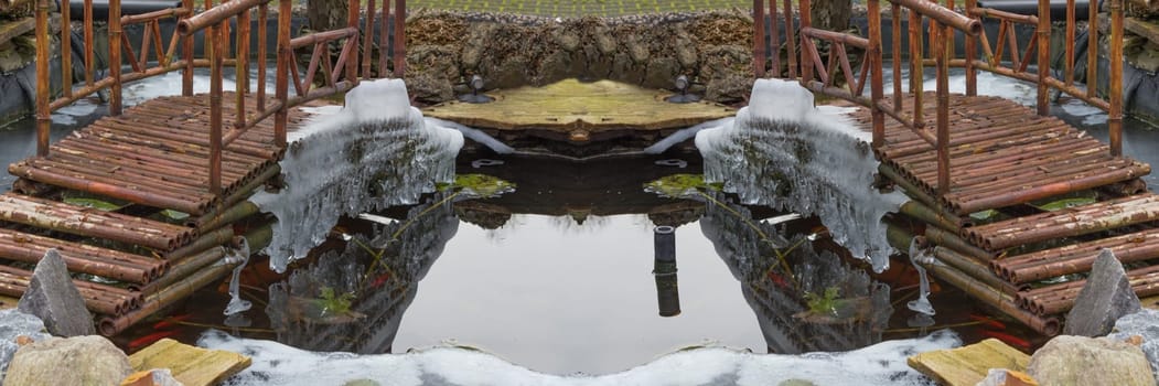 Icicles hang from a bridge over a frozen lake.
