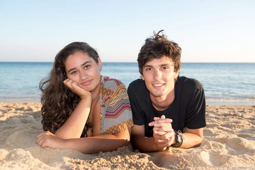 Happy young couple posing in the beach