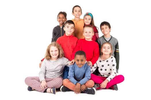 Group of happy children posing isolated in white