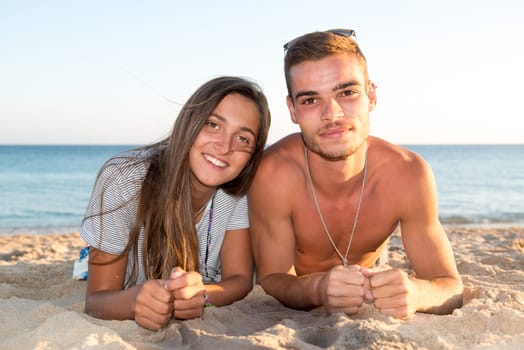 Happy young couple posing in the beach