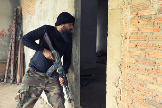 terrorist in black uniform and mask with kalashnikov ak47