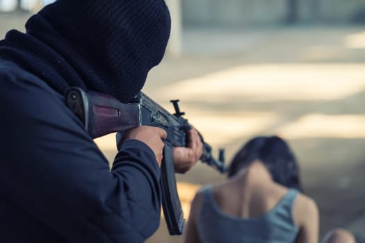 Man in balaclava threatening with gun to woman abducted