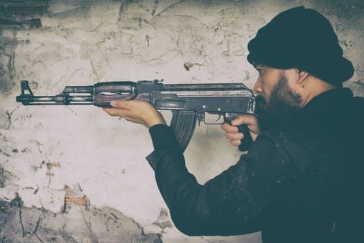 terrorist in black uniform and mask with kalashnikov ak47