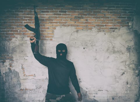 terrorist in black uniform and mask with kalashnikov ak47