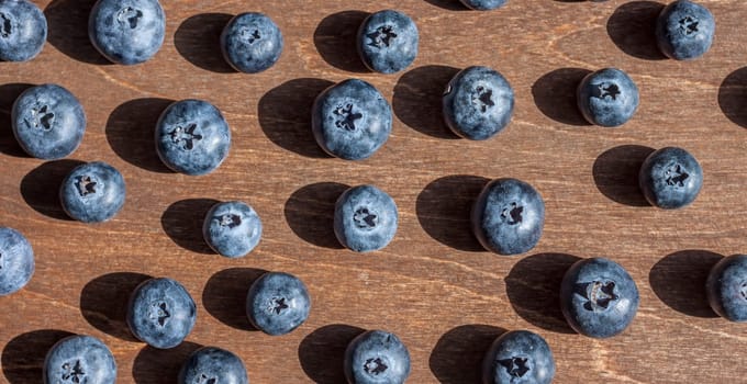 fresh big delicious blueberries wooden background bright shadows