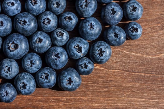 fresh big delicious blueberries wooden background free space for text