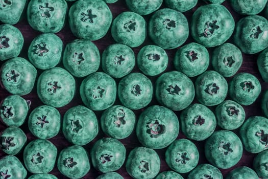 fresh big delicious blueberries in sun light green toned