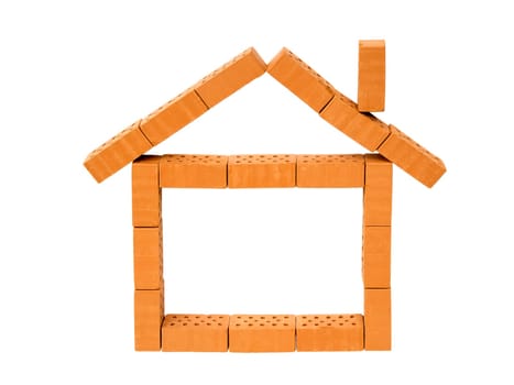 Indicated house made of toy bricks on white background