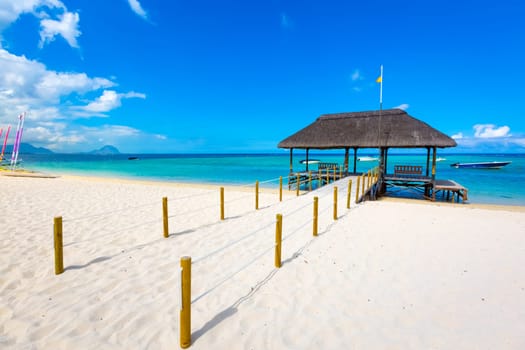 Sandy tropical Wolmar beach at sunny day. Jetty on the foreground.  Mauritius