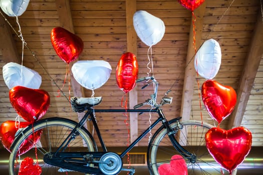 Flying bike bound to heart shaped balloons