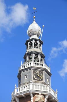 Church tower with a beautiful clock,and blue sky in the background.