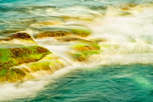 Surf of the Atlantic Ocean with rocks in long exposure