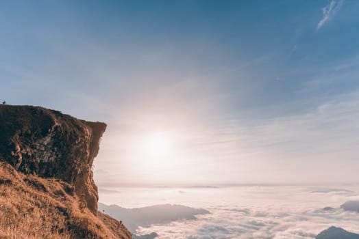 Vintage style in Sienna-Blue color two tone, beautiful landscape nature of sunrise on peak mountain with cloud fog and sky in winter at Phu Chi Fa Forest Park, Chiang Rai Province, Thailand
