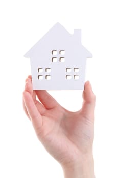 Hand holding miniature model of house on white background
