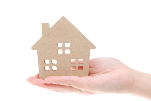 Miniature model of house on the hand, isolated on white background