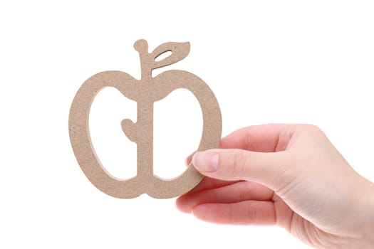 Hand holding imitation of wooden apple on white background