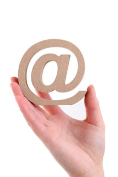 Hand holding wooden email symbol isolated on white background