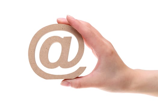 Hand holding wooden email symbol isolated on white background