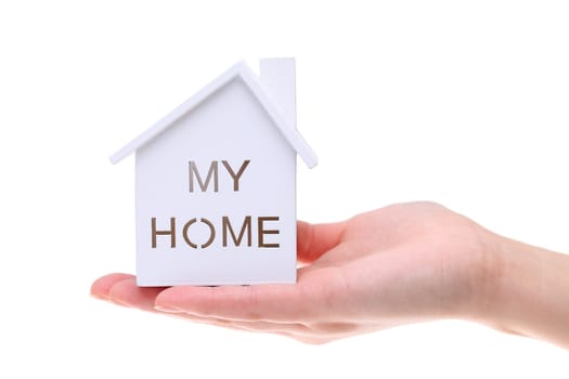 Miniature model of house on the hand isolated on white background