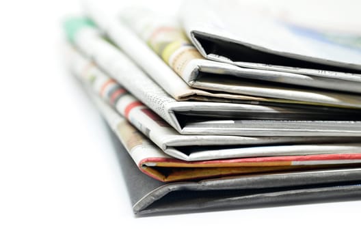 Newspapers folded and stacked isolated on white