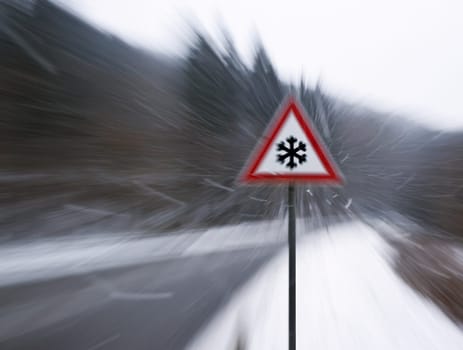 A photography of a zoom to an icy street sign with snowfall