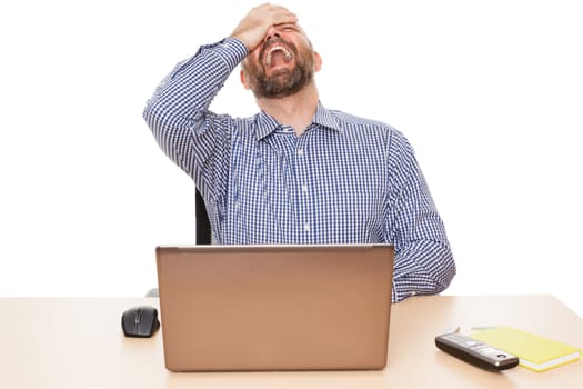A depressed businessman at his desk against a white background