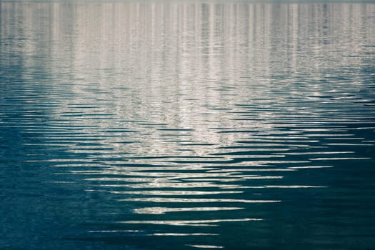 Gentle waves with reflections on an alpine lake in the Canadian Rockies