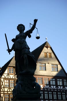 Frankfurt,Germany - January 05,2017: The sculpture of the Fountain of Justice on the Römerberg carries the moon in the weighing pan on January 5,2017 in Frankfurt.