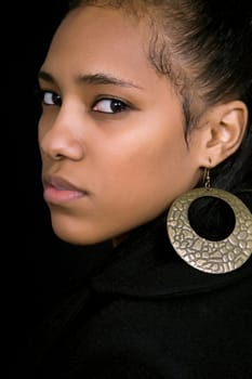 young beautiful woman close up portrait, on black background