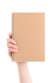Hand holding blank spiral notebook on white background