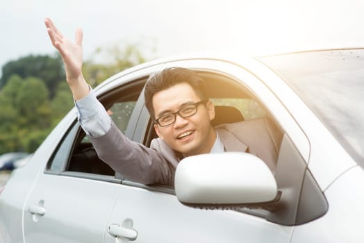 Close up portrait of angry pissed off young business man pissed off by other drivers and gesturing with hands. Road rage traffic jam concept.