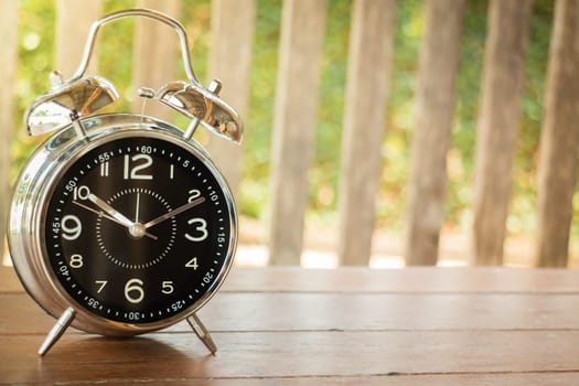 Alarm Clock On Wooden Blackground