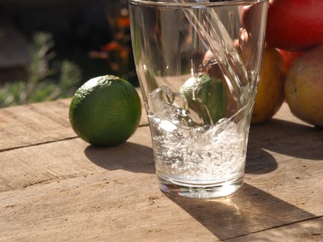 Old wooden garden table with fresh ingredients of homemade juice