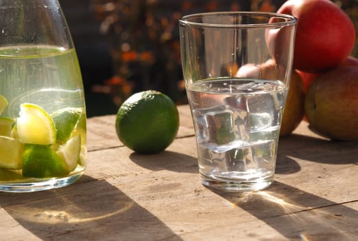 Old wooden garden table with fresh ingredients of homemade juice