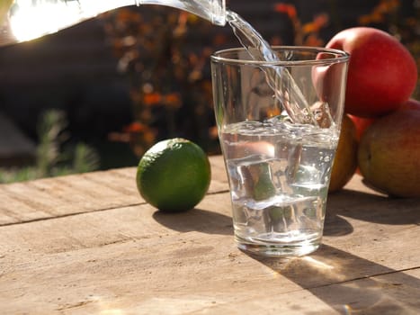 Old wooden garden table with fresh ingredients of homemade juice