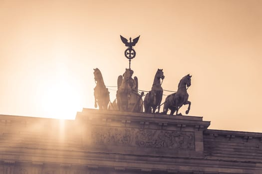 Sunset behind the german symbol and landmark Brandenburger Tor at Pariser Platz in the german capital berlin city.