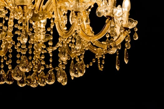 Noble candelabra hanging on ceiling with lots of little gems.