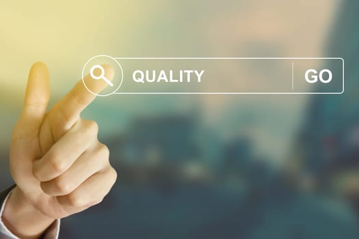 business hand clicking quality button on search toolbar with vintage style effect